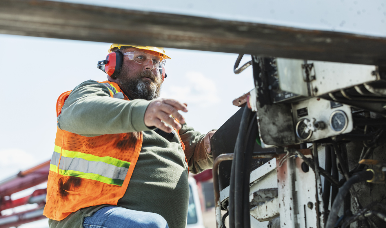 A construction worker on a concrete pump on a USA construction site